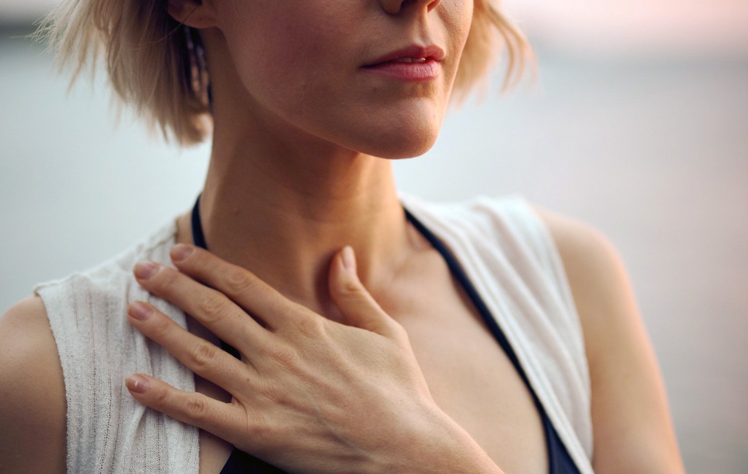Woman holding a hand on her neck
