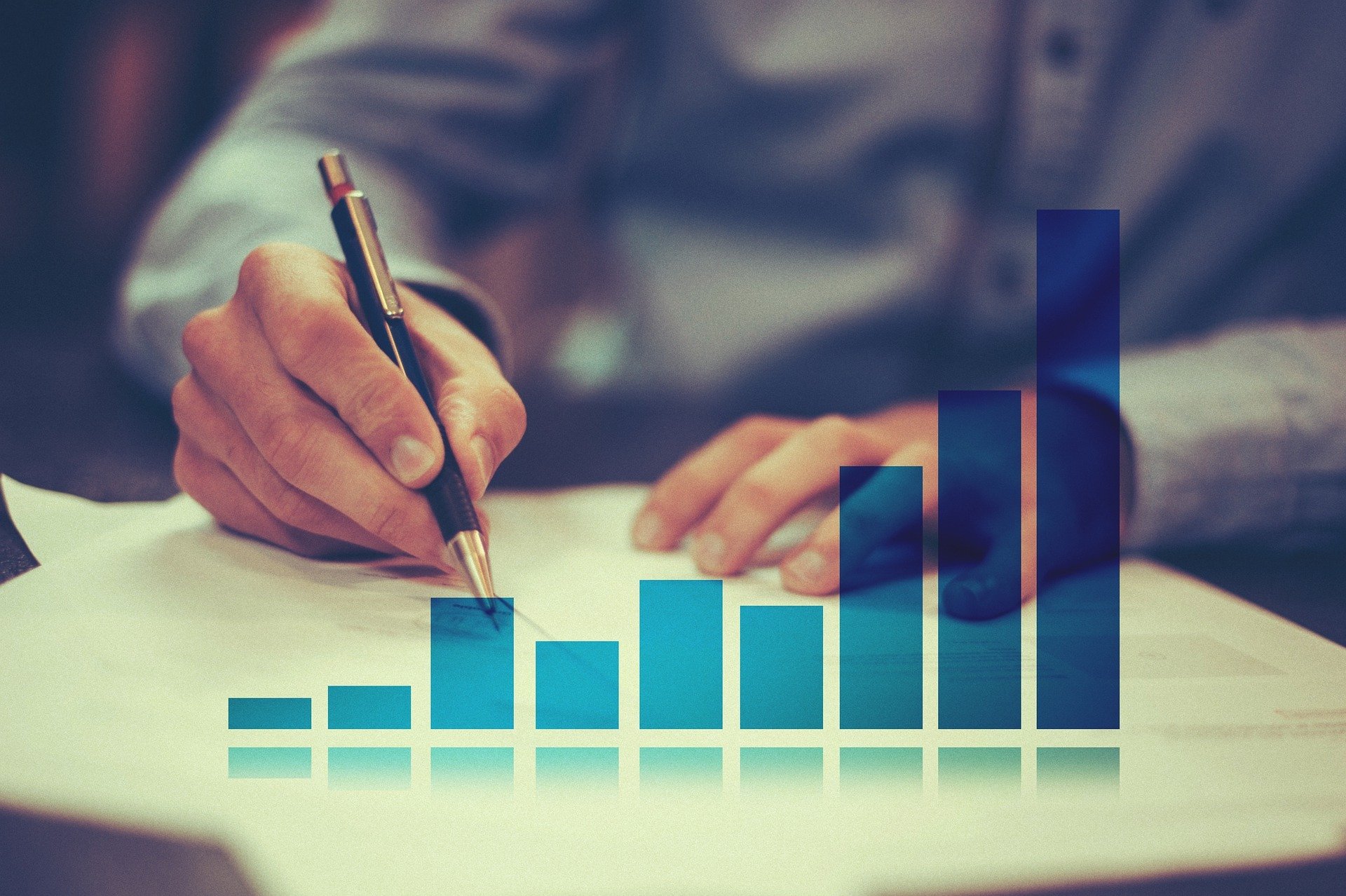 Hands writing, illustrating statistics and planning.