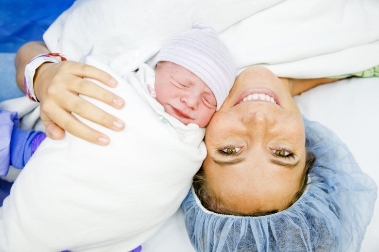 Photo of woman with baby after childbirth.