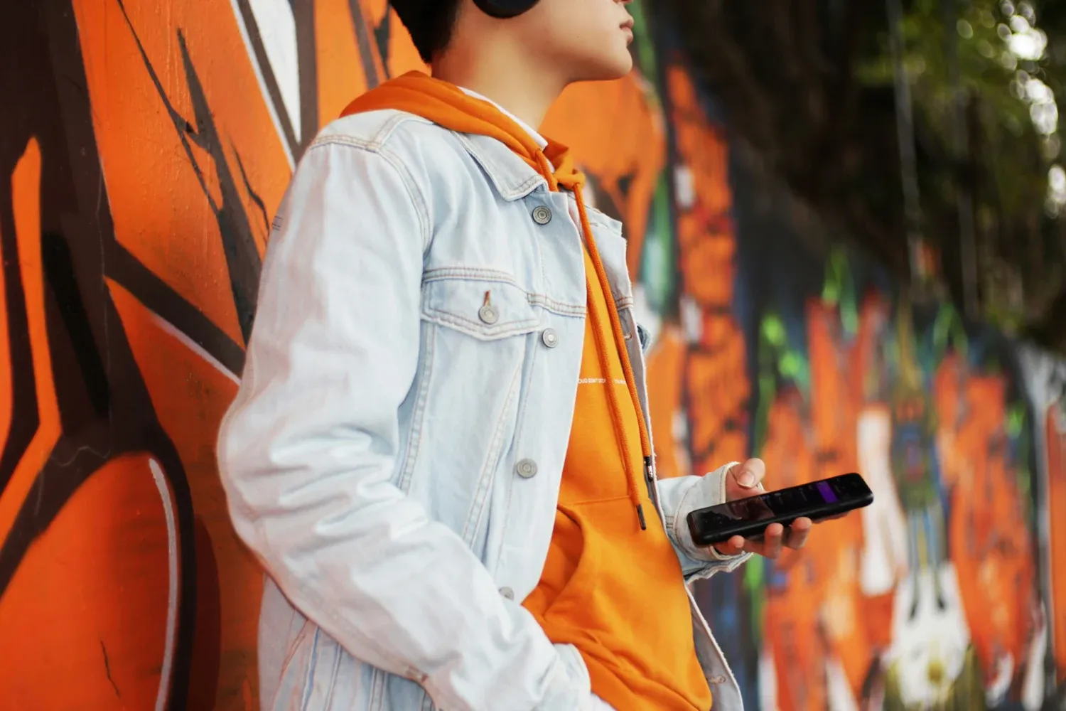 Women white jacket holding a phone
