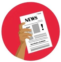 Hand holding a newspaper