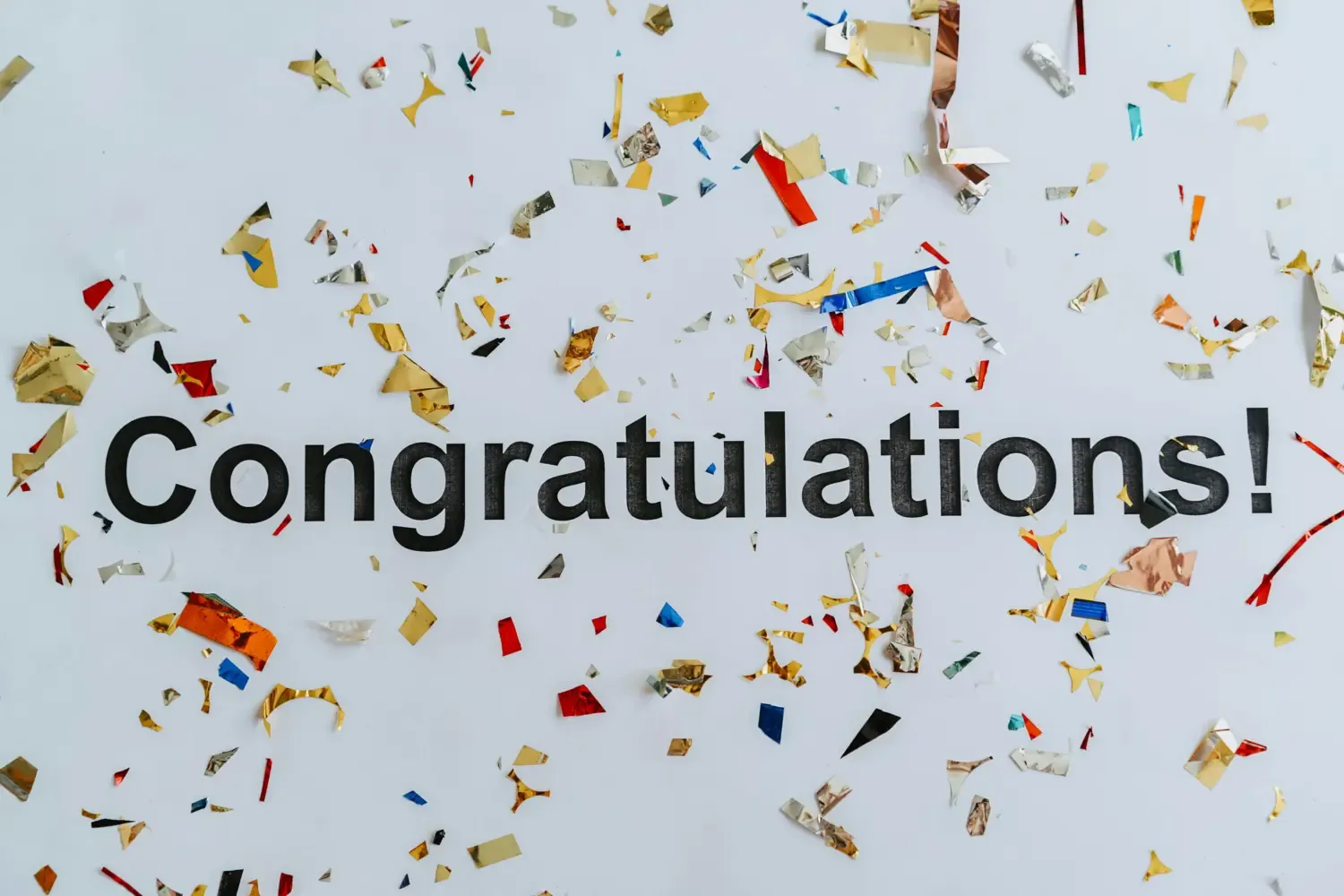 The text "Congratulations!" on a background of confetti.