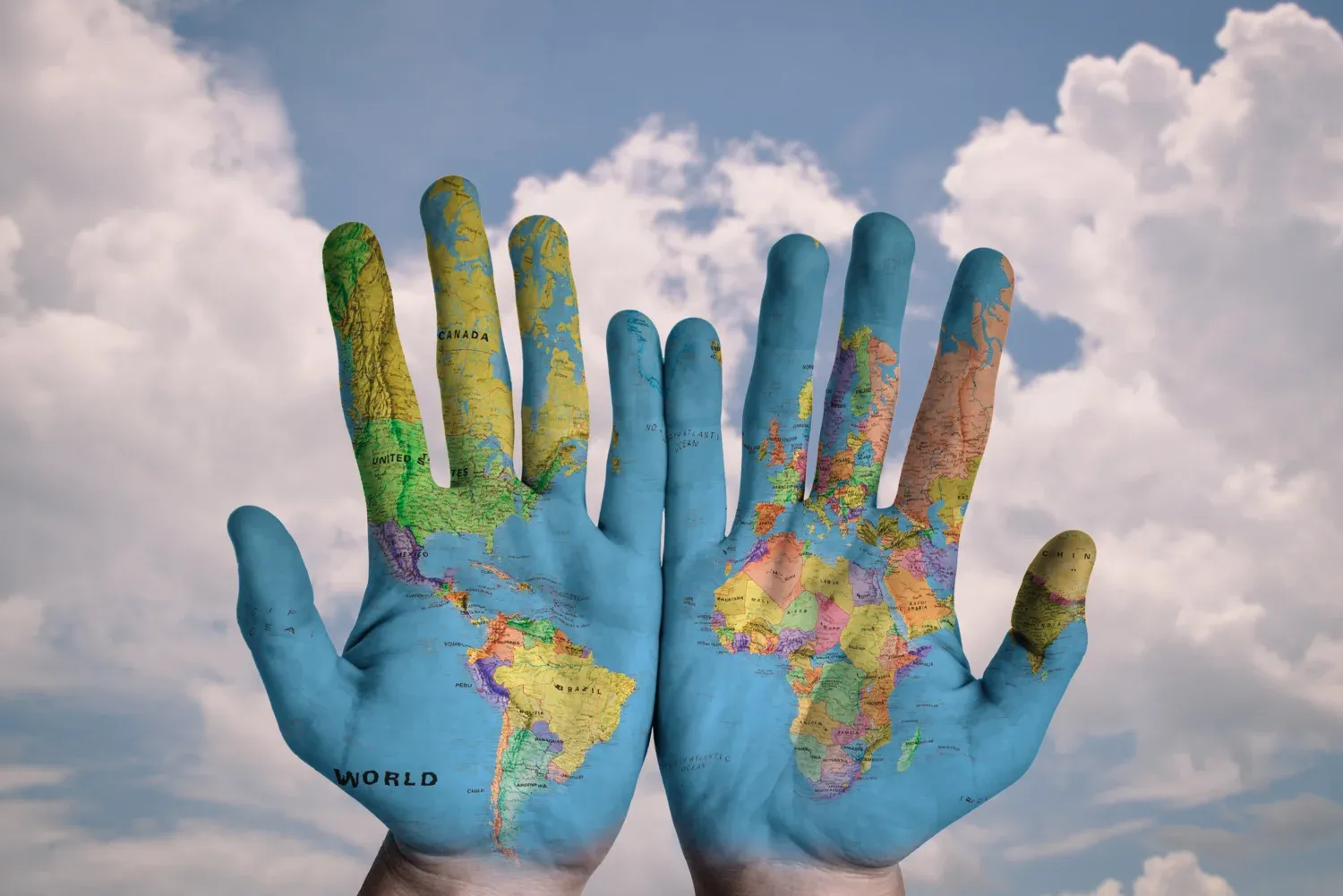 Two blue palms with the world map painted on them.