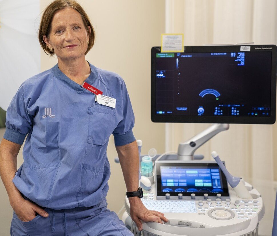 A women standing in a clinical setting.