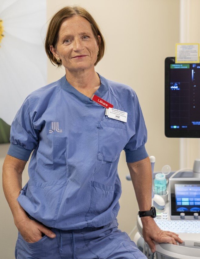 A women standing in a clinical setting.