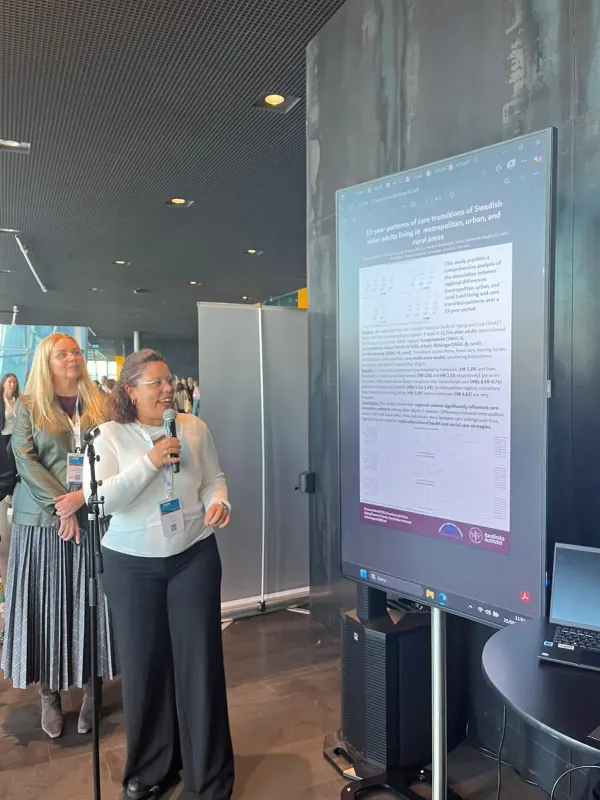 Susanna Gentili with a microphone in front of her poster.