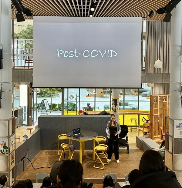 Speaker standing on stage during a presentation
