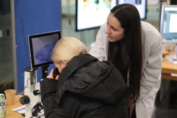 Visitor looks in a microscope to get a closer look inside the brain.
