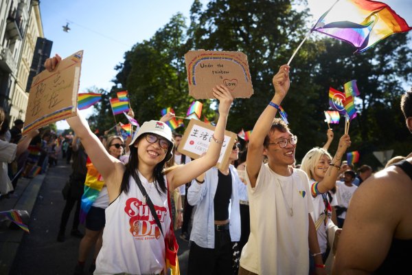 Students and other participants in the Pride parade. Rainbow flags and happy people.