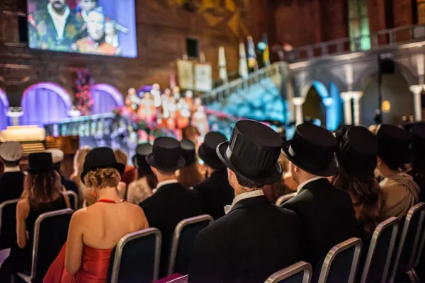 Newly minted doctors in their hats sitting in the audience.