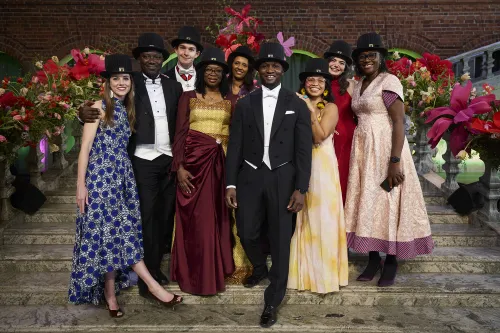 A group photo of newly graduated doctors from the Department of Global Public Health dressed in formal attire.