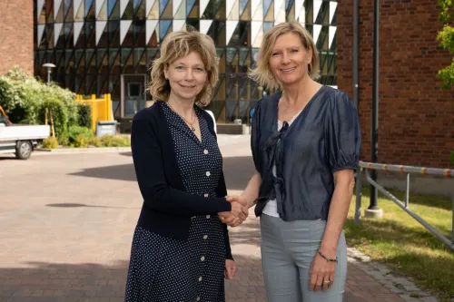 Two women shaking hands