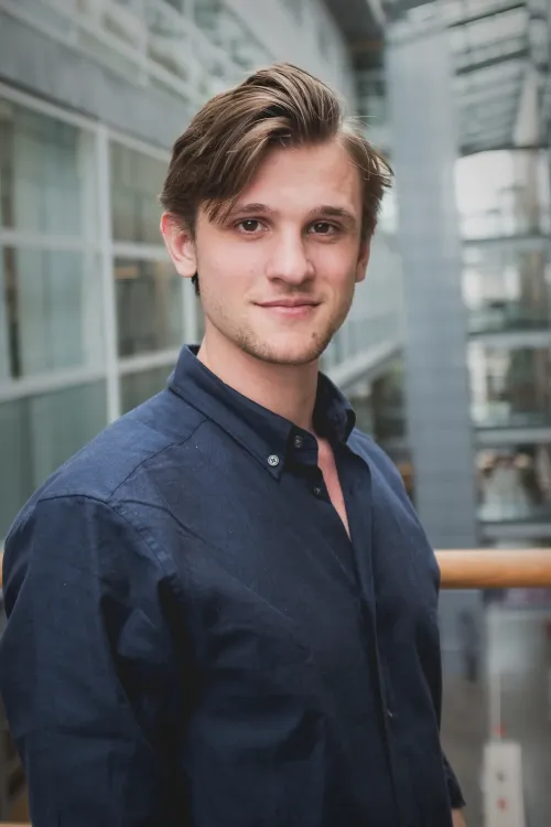 Portrait of a man in a dark shirt.
