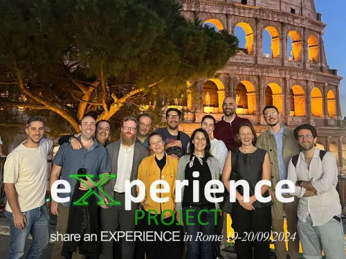 A group photo of the members in the EXPERIENCE team standing in from of the Colosseum, Rome.