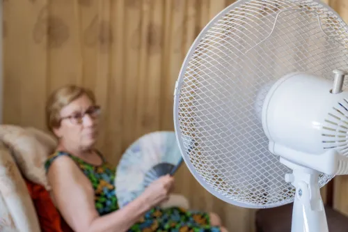 Woman in front of a fan during a heatwave