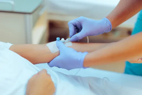 Stock photo showing intravenous drip being given to a patient.