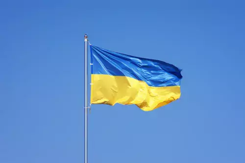 Ukraine&#039;s flag against a blue sky.