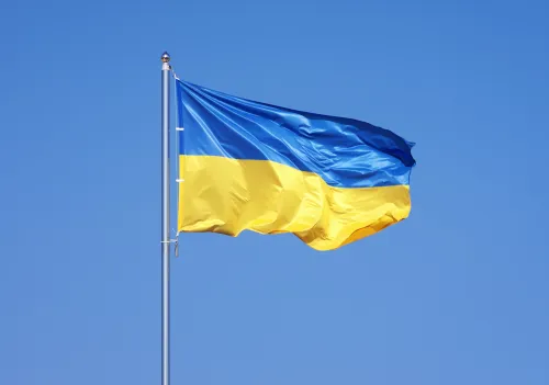 Ukraine&#039;s flag against a blue sky.