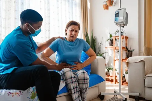 A woman with stomach pain being examined by a doctor. Photo: Getty Images