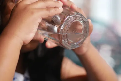 A young child drinking water. Photo: Getty Images