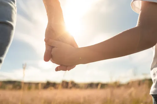mother and child walking in a field