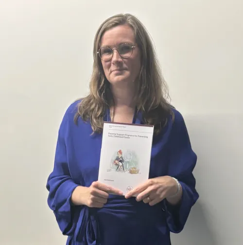 a woman helding a thesis
