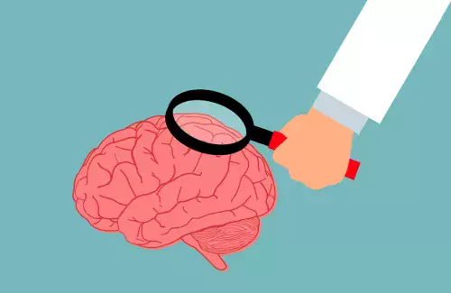 illustration of a hand holding a looking glass over a brain.