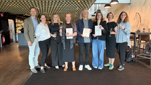 A group photo of the grant recipients holding their certificates.