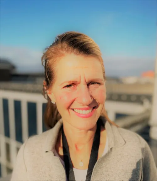 Portrait photo of woman with sky as background.