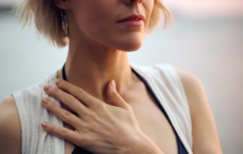 Woman holding a hand on her neck