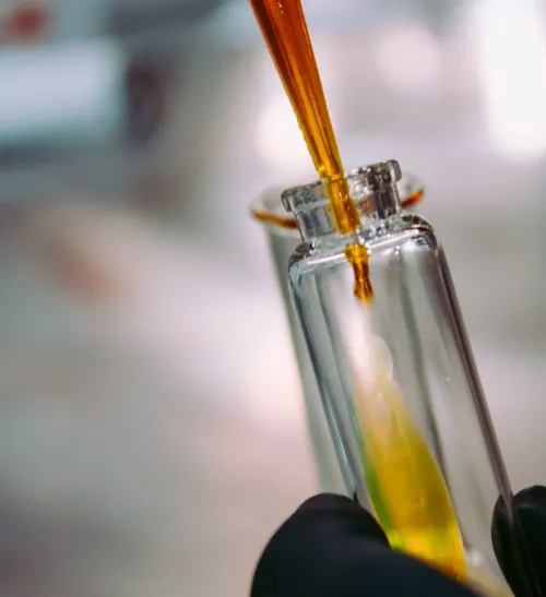 Clear glass bottle with yellow liquid