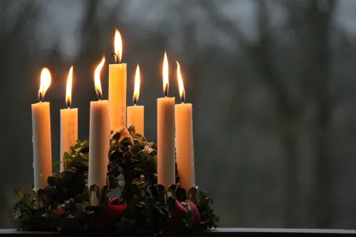 A picture of a crown with lighted candles.