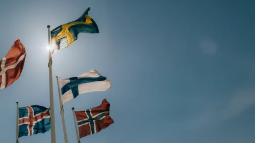 All the flags of the Nordic countries waving in the wind.