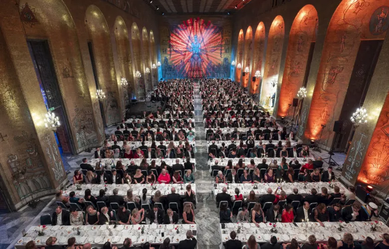 Overwiev photo of the Golden Hall during the banquet. The guests are sitting at their tables waiting for dinner.